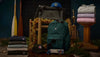 Collection of backpacks and bags displayed on a dark background with decorative elements.
